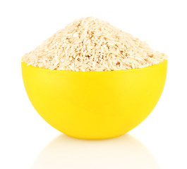 brown rice in a yellow plate , isolated on white
