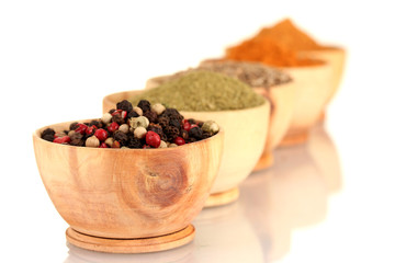wooden bowls with spices isolated on white