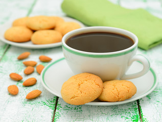 Coffee and almond cookies on a white table
