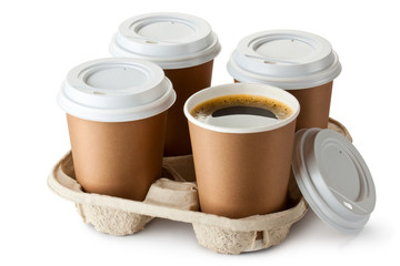 Four take-out coffee in holder. One cup is openend. - 46904184