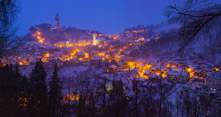 Snowy evening view of the lighted town