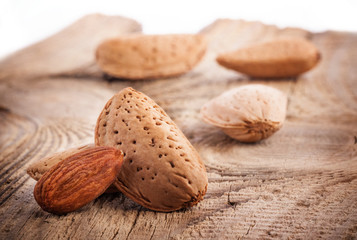 Almond nuts on old wooden table, closeup