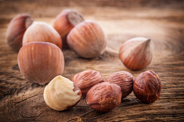 Hazelnuts (filbert) on old wooden table. Close-up