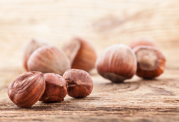 Hazelnuts (filbert) on old wooden table. Close-up