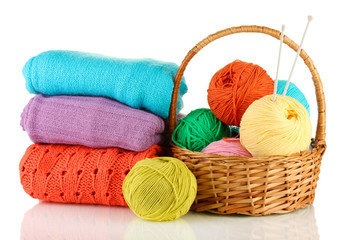 Sweaters and balls of wool isolated on white
