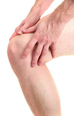 man holding sore knee, isolated on white