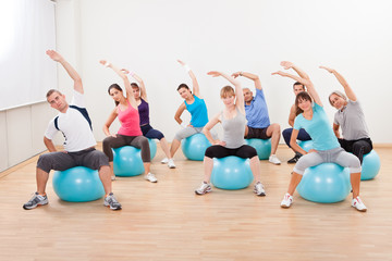 Pilates class exercising in a gym © Andrey Popov