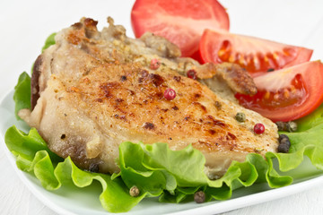 roasted pork fillet on a piece of lettuce and tomato