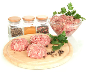 Raw meatballs with spices isolated on white