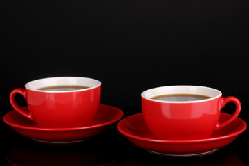 A red cups of strong coffee isolated on black