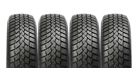 Stack of four car wheel winter tires isolated