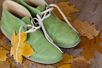 green leather boots and yellow leaves