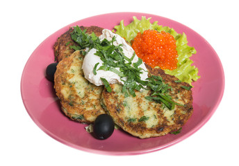 Roasted cutlets of potato with salmon on a plate