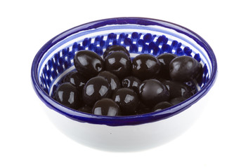 Olives black watered with olive oil in a bowl isolated on a whit