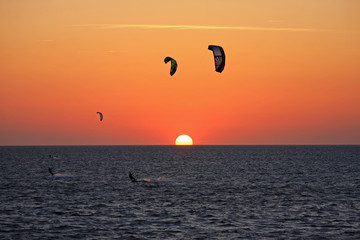 kitesurfers at sunset