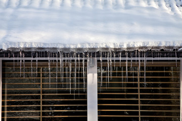 Icicles on the roof of the house.