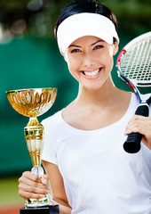 Female tennis player won the cup at the sport competition. Prize