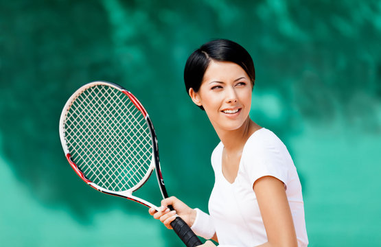 Portrait of tennis player with racket at the tennis court