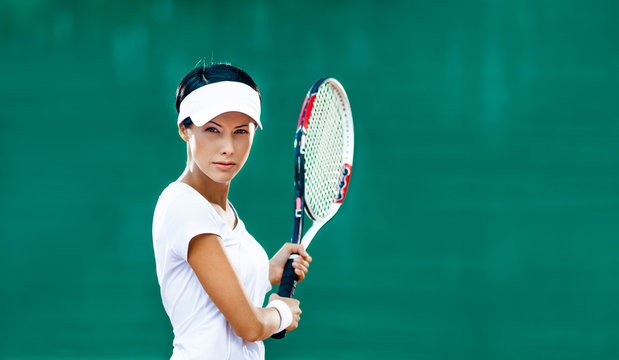 Woman in sportswear plays tennis at match