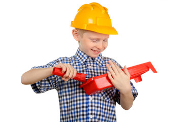 Boy in the construction helmet and a paint roller