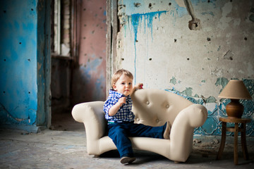 Adorable baby in the chair. Old house.