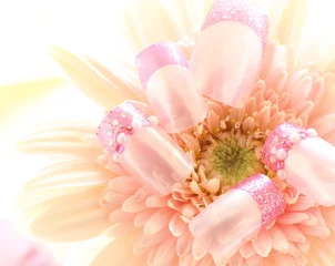 close up of pink gerbera and nails 