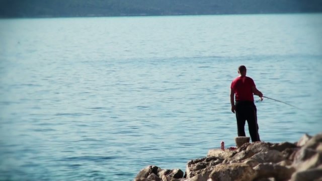 Fisherman fishing at sea