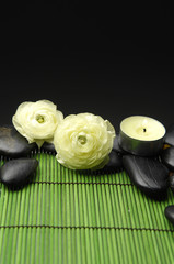ranunculus with stones with candle green mat