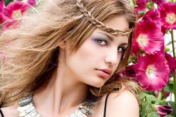 Naklejka premium beautiful woman in garden with flowers