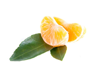 Two segments of mandarin with green leaves