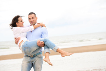 Portrait of a happy young couple at the sea shore