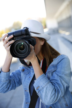 Woman photographer taking professional pictures