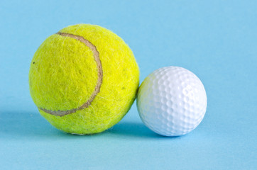 golf and tennis balls on azure background