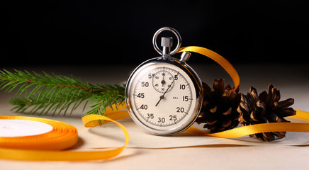 Stopwatch and christmas decoration on black