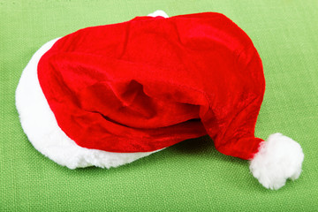 Santa Claus hat on the green cloth.