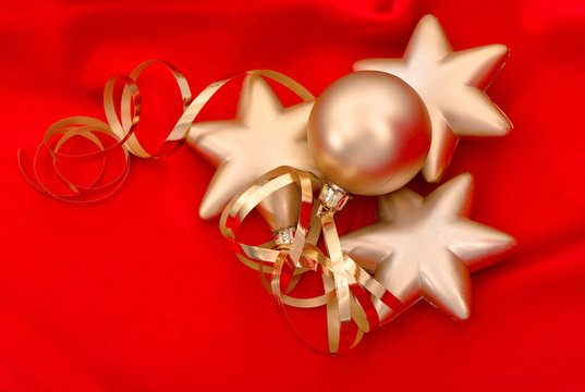 golden christmas balls over red silk background