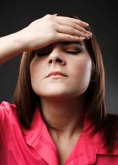 Woman with migraine holding her head