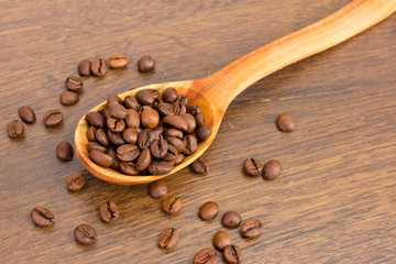 Wooden spoon with coffee beans