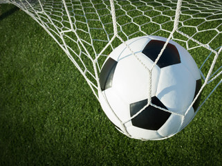 Soccer ball in goal, success concept