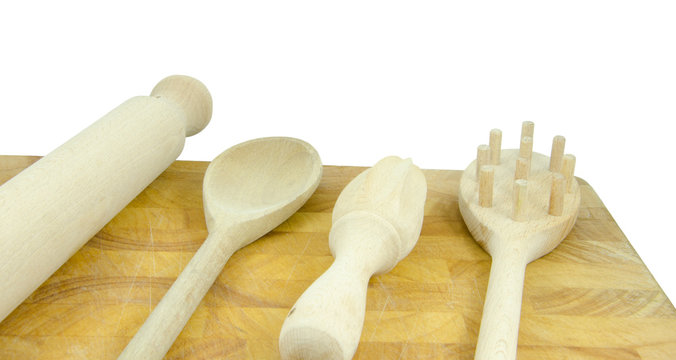 wooden kitchen tools on chopping board