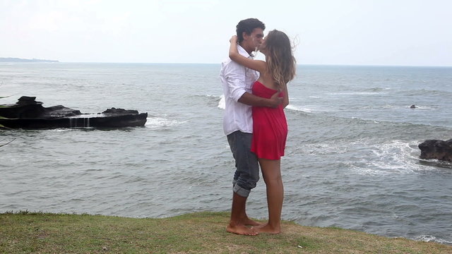 Happy lovers kissing and hugging at bali coast