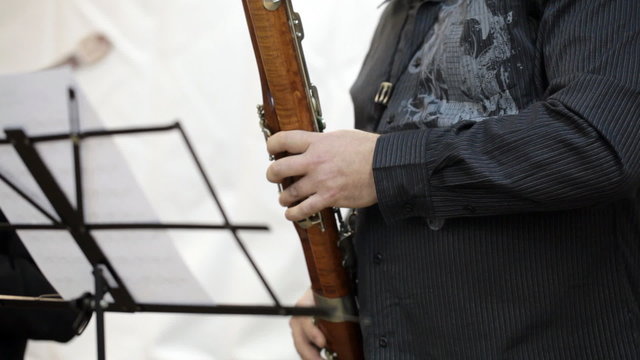 The musician plays the bassoon
