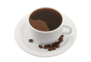 Cup of black coffee on a saucer with coffee beans