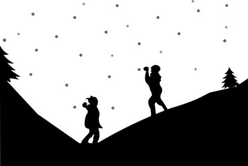 Kids in a snowball fight in winter in mountain silhouette