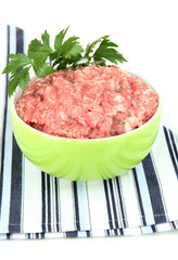 Bowl of raw ground meat isolated on white