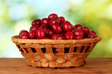 fresh cornel berries in wicker basket