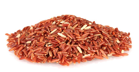 red  rice uncooked in a heap isolated on a white background