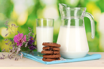 Pitcher and glass of milk with cookies