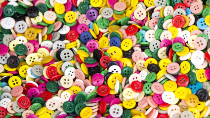 Background or texture of a pile of buttons of many colors and si