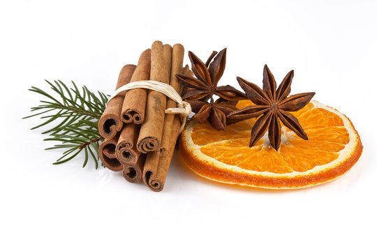 orange slice, cinnamon with fir branch isolated on white